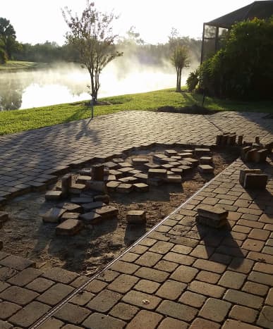 We started the removal ourselves, so that a friend could have some of the pavers for her patio. It was hard work with inadequate tools (a trowel, crowbar, and a shovel)