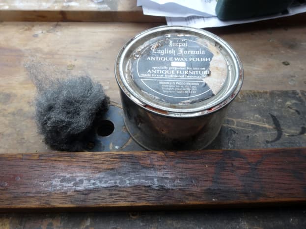 Applying coloured beeswax polish with wire wool.