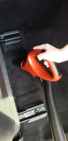 My son helping me clean the car. The top handle detaches for close up cleaning.