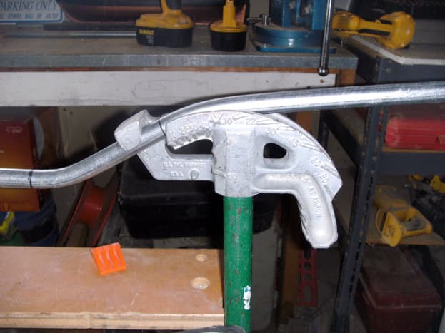Conduit placement for the second bend of an offset.  Marks were placed on the arrow.  This bend is complete with the conduit matching the 22 degree mark on the bender.