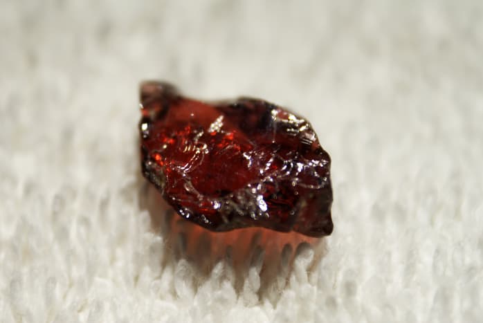 This is a raw cut piece of garnet. Its blood red colour makes it highly popular with jewellery makers. 