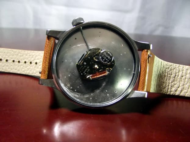  Komono Winston Quartz Watch with case back removed. Note the tiny levers which allow easy removal of the strap.