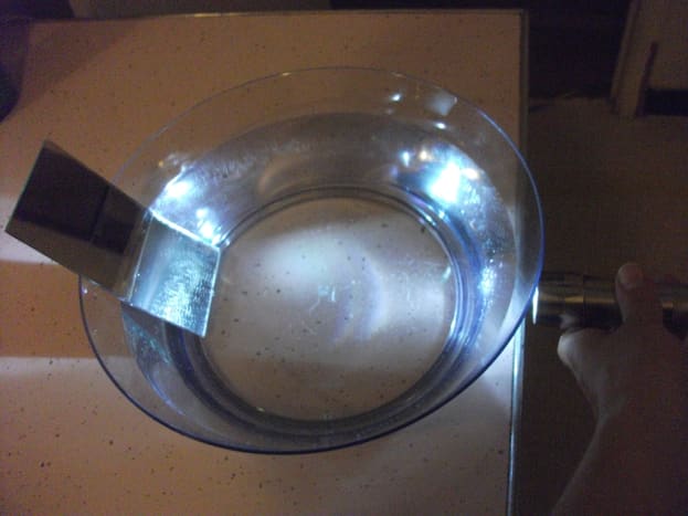 Making rainbows using a flashlight, bowl of water, and a mirror.