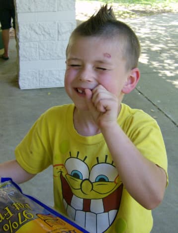 Wyatt eating beef jerky on his 7th birthday. Notice the rug burn on his forehead? This is from headbutting the floor while being restrained at his special school for emotionally disturbed children.