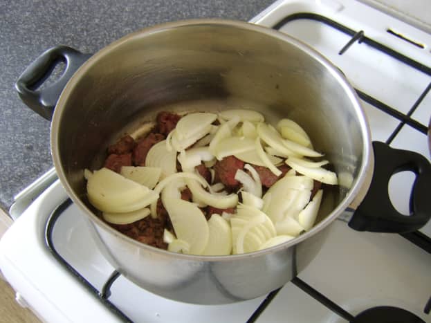 The sliced onion is added to the browned venison
