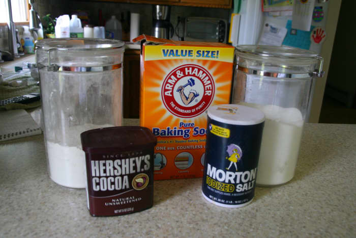 The dry ingredients for Wacky Cake: flour, baking soda, cocoa powder, and sugar.