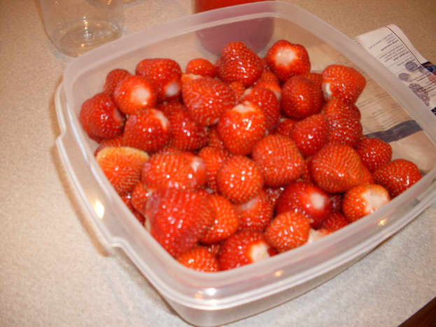 First, take the tops off of the strawberries and clean them. 