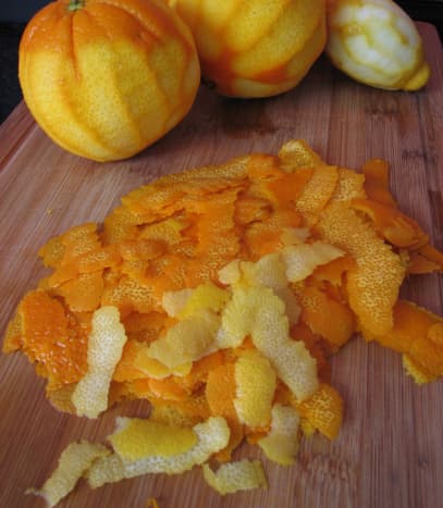 Oranges (and one lemon) are peeled, and the peel is ready for cutting into slivers.
