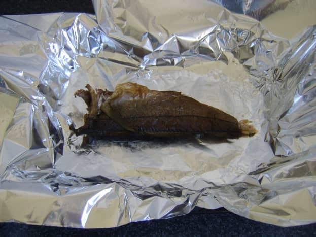 Arbroath smokie is laid on lightly buttered foil