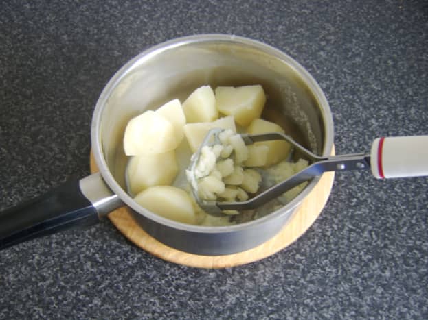 Cooked potatoes are mashed with a little milk and butter