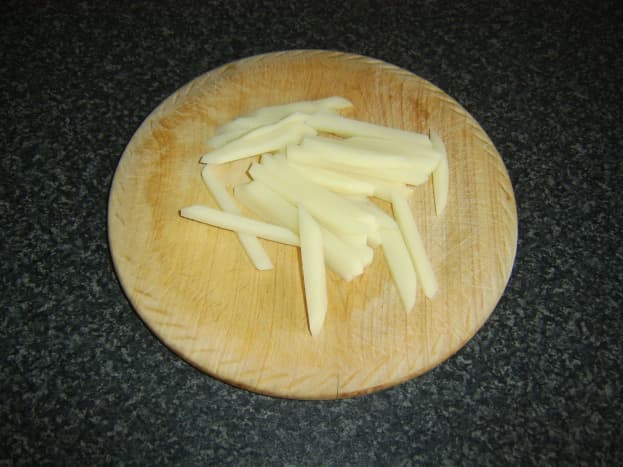 Potato is peeled, sliced and chopped in to fries