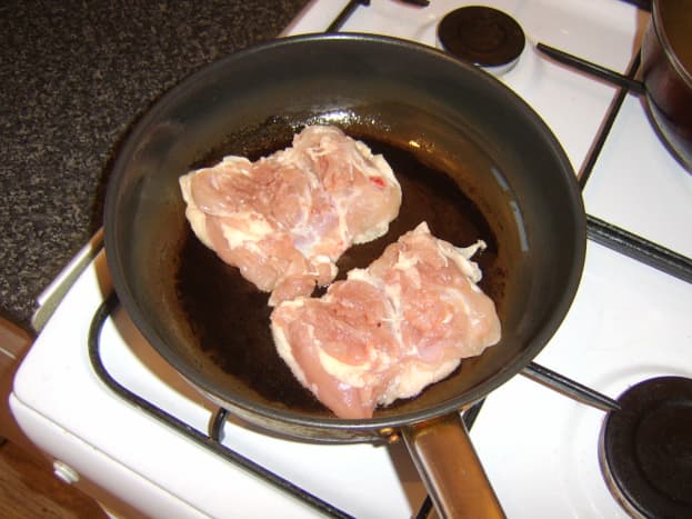 Browning and sealing the boned chicken thighs