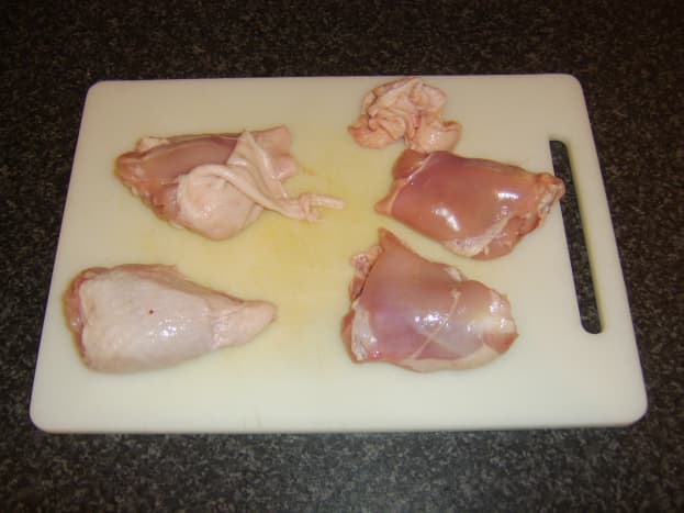Skin is peeled from chicken thighs