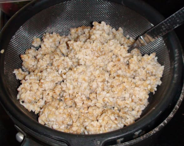 The cooked oatmeal draining and cooling. I place the hot oatmeal into a metal colander and let it sit for about 30 minutes. All the excess liquid will drain out. Fluff it with a fork.