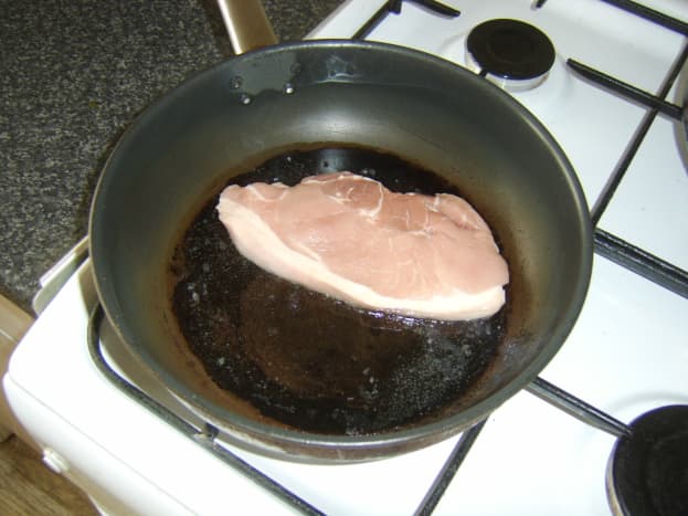 Pan frying a leg of pork steak