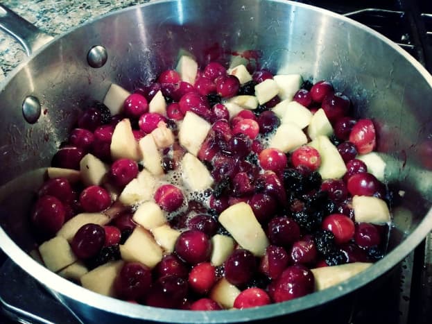 The cranberry-apple mixture is beginning to boil. 