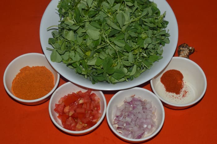 Step one: Keep the ingredients ready. Make a seasoning as per instructions. Saute onions and tomatoes. Add chopped fenugreek leaves. Stir-cook them. Add all other spice powders and salt . Saute for a minute.