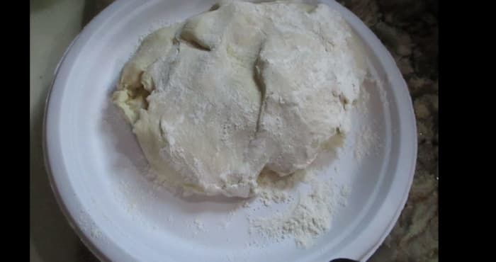 Take the dough ball out and coat both sides with flour.