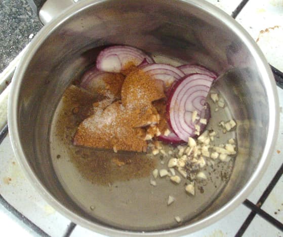 Onion, garlic, seasonings and spices are added to a saucepan