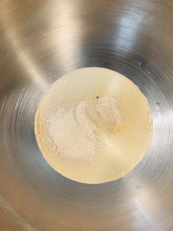 In a mixing bowl, combine warm water, active dry yeast, and sugar or honey. 