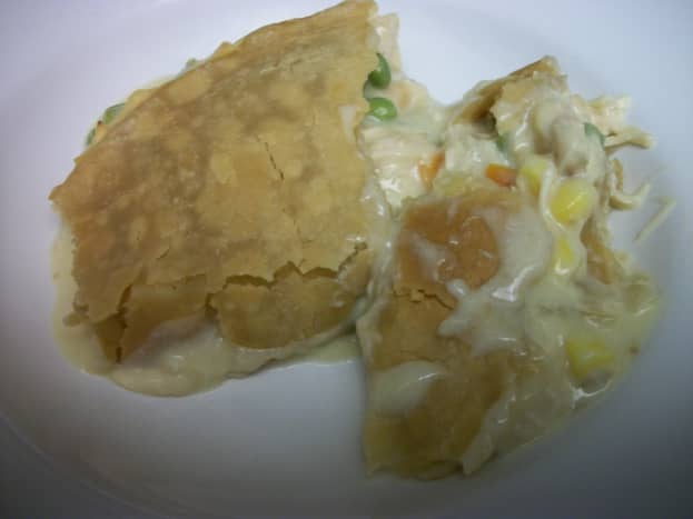 Classic chicken pot pie, family style, with potatoes, corn, carrots, and peas. 