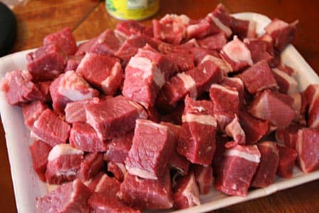 You want your beef brisket to be trimmed of its fat and cut into cubes like in the photo here. 