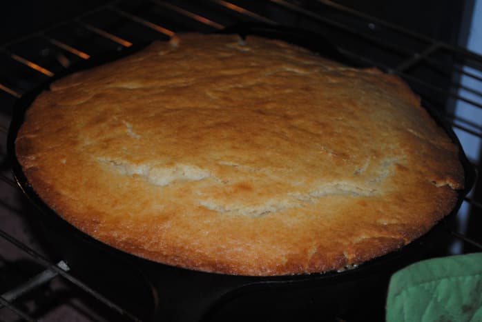 The foundation of a pineapple upside-down cake is a beautiful yellow cake base. It should puff and turn golden brown.