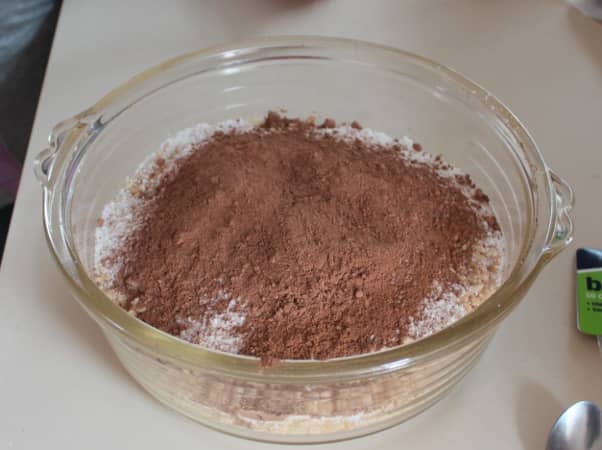 Mix all of the dry ingredients together: soft icing sugar, coconut, cocoa, and Rice Bubbles.