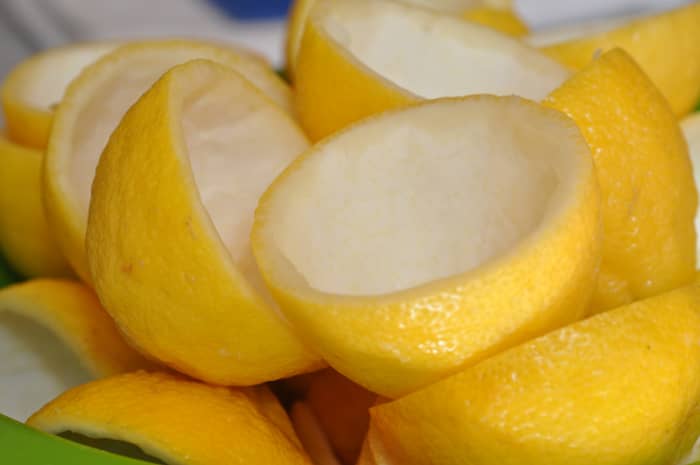 Step 1: Prepare the lemons. (Juiced lemon halves with pulp removed, ready for candying.)