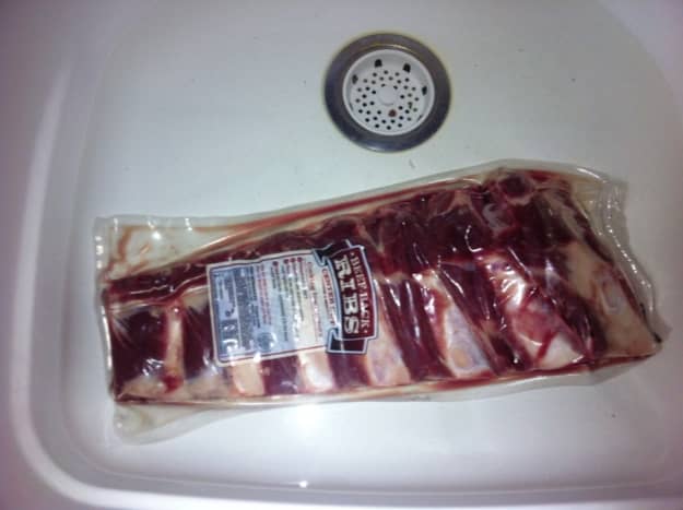 Defrosting the ribs in their plastic packaging