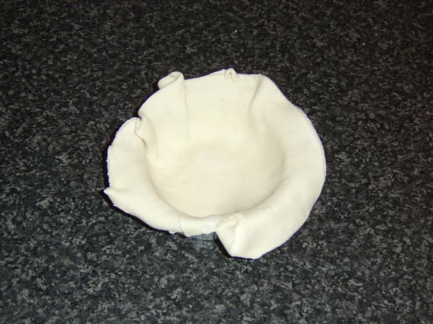 Pastry is carefully shaped in the foil pie dish