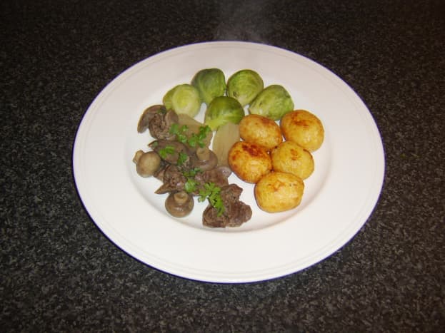 Chicken liver and mushroom casserole, served with pan-roasted baby new potatoes and Brussels sprouts.