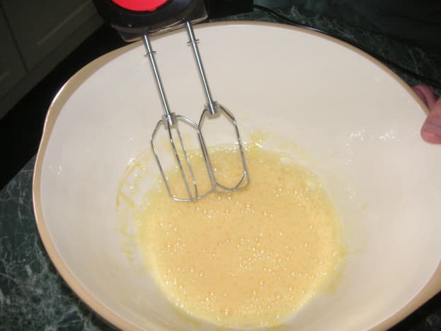 Beat all the eggs with a hand mixer in a large bowl until they are pale and full of air.