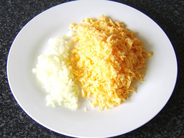 The cheese is grated, and the onion is finely chopped.