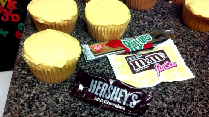 We used fun size Hershey's chocolate bars, M&amp;M's, and Fruit Roll-Ups to decorate our cupcakes.