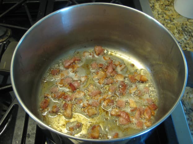 Chop the salt pork or bacon into small pieces, then brown lightly in your stock pot or Dutch oven.