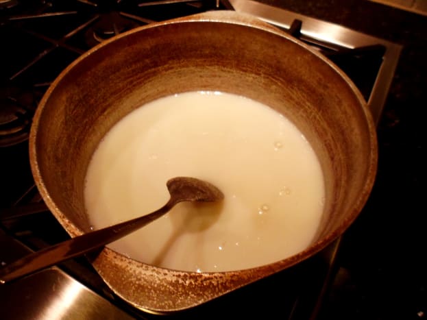 Mix together sugar, milk, and salt in large pot.