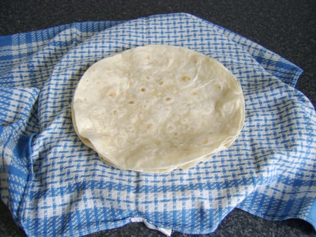 Wraps are heated one by one and kept moist in a warm, damp tea towel.