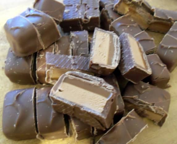 Chop the Mars Bars or similar chocolate nougat and caramel bar into pieces