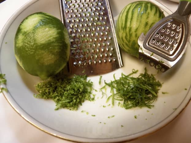 Grated lime zest is smaller, microplaned lime zest is thinner and longer.