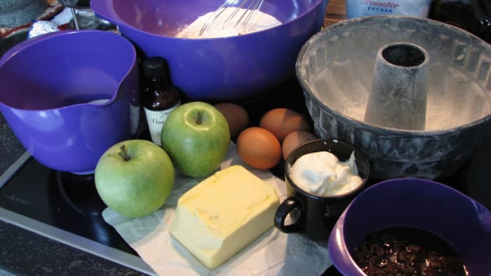 Ingredients for the apple bundt cake, and the floured bundt tin.