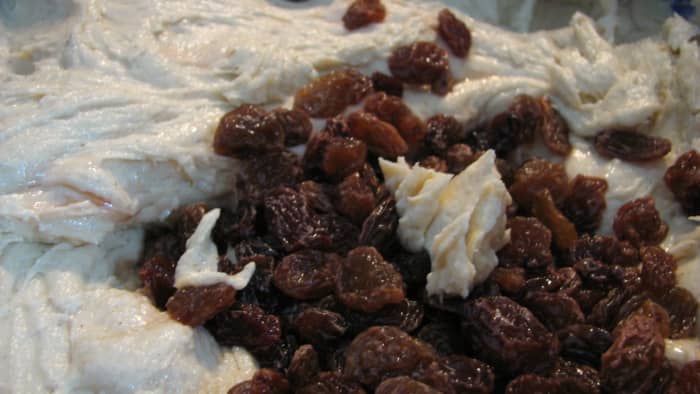 Add the rum-soaked sultanas to the cake batter.