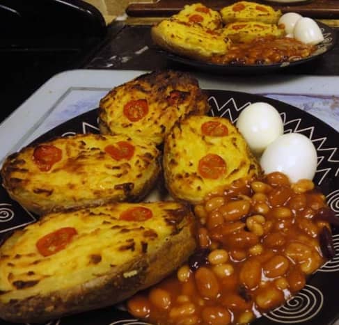 Stuffed potato Jackets with potato cheese and onion sauce served with hardboiled egg and baked beans