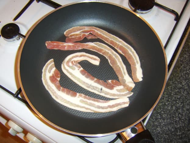 Gently frying bacon slices