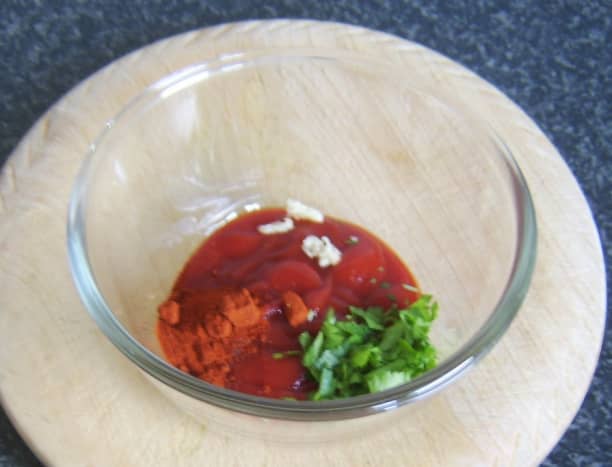 Mixing spicy tomato dip for plaice fillets