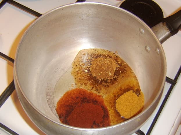 Curry spices added to vegetable oil