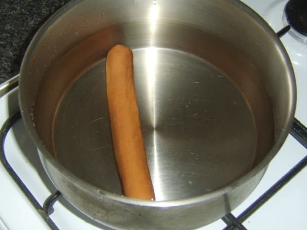 Preparing to heat hot dog.