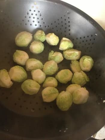 Fill a steamer with a few inches of water and let it come to a boil.  Once the water has started boiling, put the brussels sprout hearts in the top rack of the steamer.