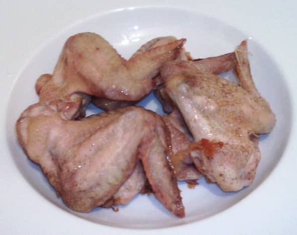 Roast chicken wings are left to rest and cool