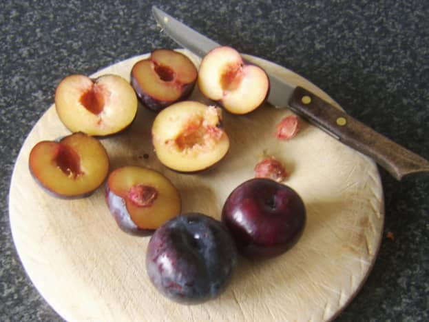 Chopping and de-stoning plums for stewing